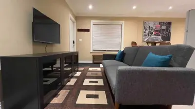 a living room with a couch and a flat screen tv at Spacious comfy stay in Richmond