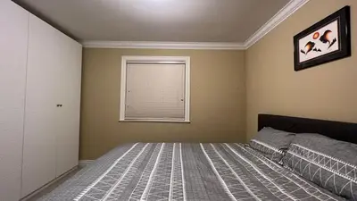 a bedroom with a bed and a window at Spacious comfy stay in Richmond