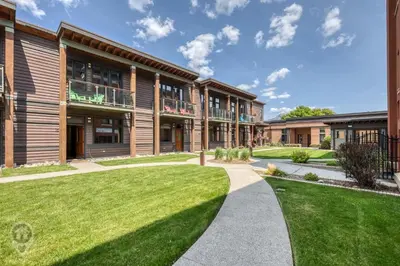 an exterior view of a building with a green lawn at 901 Fernie by StayIn in Fernie