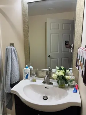 a bathroom with a sink and a mirror at Home Away from Home in Calgary