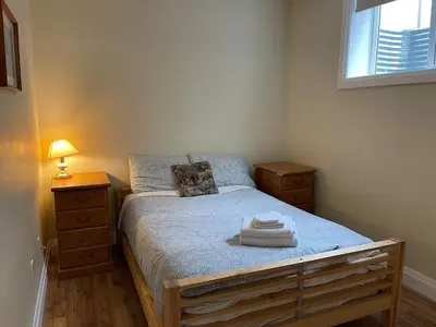 a small bedroom with a bed and a window at Spacious 6 beds 3 baths home in Central WiFi parking AC in Edmonton