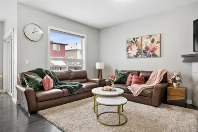 a living room with a couch and a table at Large Family 4BR w Kid's Play Den! FREE Banff Pass in Calgary