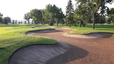 an aerial view of a golf course with twoavy depressionsacers at Large Family 4BR w Kid's Play Den! FREE Banff Pass in Calgary