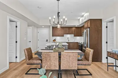 a kitchen and dining room with a table and chairs at 2 bedrooms-3 beds 2 baths - Rocky Mountain View Retreat - Heated Pool and Hot Tub in Dead Man's Flats