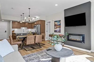 a living room with a kitchen and a dining room at 2 bedrooms-3 beds 2 baths - Rocky Mountain View Retreat - Heated Pool and Hot Tub in Dead Man's Flats