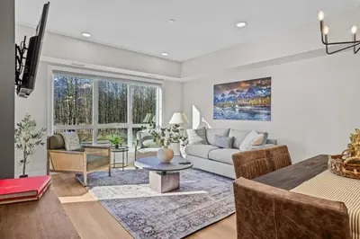 a living room with a couch and a table at 2 bedrooms-3 beds 2 baths - Rocky Mountain View Retreat - Heated Pool and Hot Tub in Dead Man's Flats