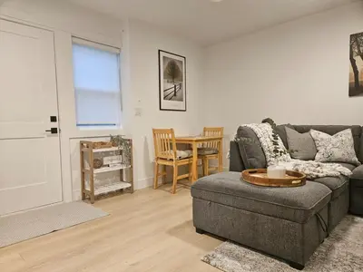 a living room with a couch and a table at Cozy new Suite in Silver Valley in Maple Ridge District Municipality