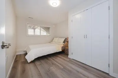 a bedroom with a bed and a sliding door at Cozy Home with 3BR 4Bath near Richmond Steveston Village in Richmond