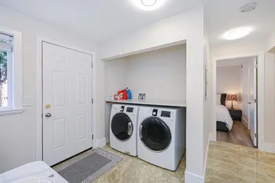 a white laundry room with a washer and dryer at Cozy Home with 3BR 4Bath near Richmond Steveston Village in Richmond