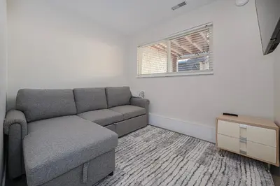 a living room with a couch and a window at Cozy Home with 3BR 4Bath near Richmond Steveston Village in Richmond