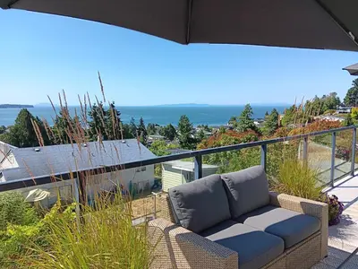 a couch sitting on top of a balcony at Sand and Salt Bed & Breakfast in White Rock