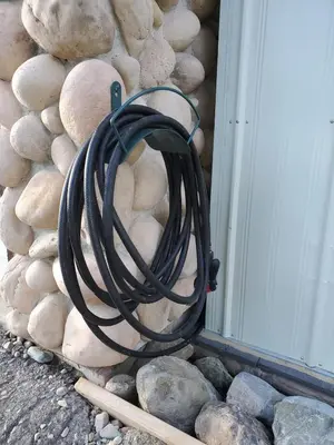 a hose hanging on the side of a building at Stemwinder Duplex Chalet by StayIn in Kimberley
