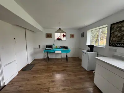 a kitchen with a blue table in a room at Surrey central house in Surrey