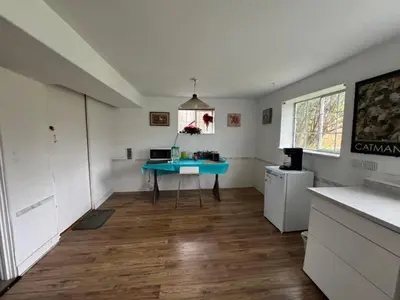 a kitchen with a blue table in the middle of a room at Surrey central house in Surrey