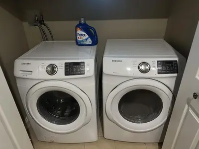 a washer and dryer in a small room at Rosehouse 2Bedrooms sleep 4 2nd floor private bathroom in Coquitlam