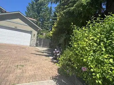a driveway of a house with a garage at Rosehouse 2Bedrooms sleep 4 2nd floor private bathroom in Coquitlam