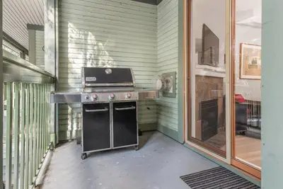 an outdoor kitchen with a stove in a house at Whistler Village Condo Sleeps 7 in Whistler