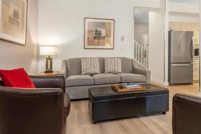 a living room with a couch and a table at Whistler Village Condo Sleeps 7 in Whistler