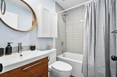 a bathroom with a sink and a toilet and a mirror at Silver Springs Family Retreat in Calgary