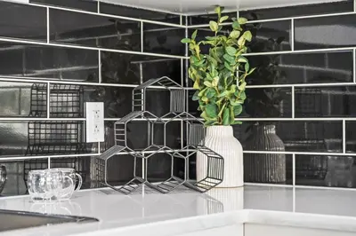 a counter with a vase with a plant in it at Silver Springs Family Retreat in Calgary