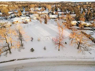 an aerial view of a snow covered city with trees at Silver Springs Family Retreat in Calgary