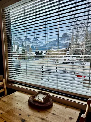 a table with a hat sitting on top of a window at Pika's Place Bed and Breakfast in Canmore