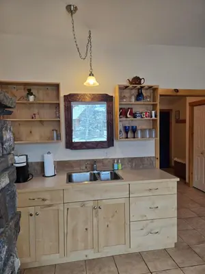 a kitchen with a sink and a window at Pika's Place Bed and Breakfast in Canmore