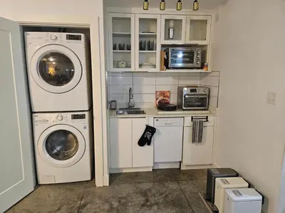 a laundry room with a washer and dryer at The Ridge in North Vancouver