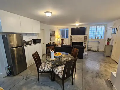 a kitchen and living room with a table and chairs at The Ridge in North Vancouver