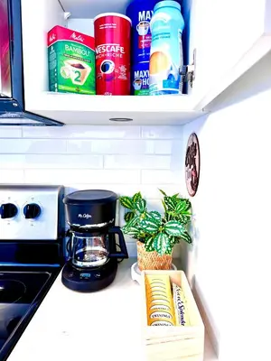 a kitchen counter with a coffee maker and a plant at Bow River Cabin - Downtown - River Front - Free Street Parking in Calgary