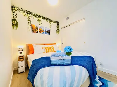 a bedroom with a bed with blue flowers on it at Bow River Cabin - Downtown - River Front - Free Street Parking in Calgary