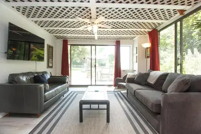 a living room with a couch and a table at Cole's Bay Vacation Retreat Cole's Bay Suite in YYJ