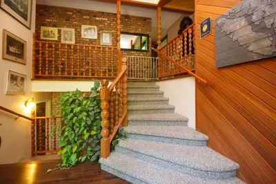 a staircase in a house with a green plant at Cole's Bay Vacation Retreat Library Room in YYJ
