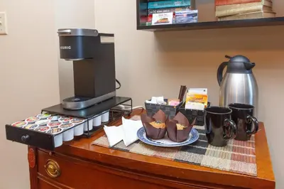 a counter with a coffee maker and a plate of food at Cole's Bay Vacation Retreat Petie's Cottage in YYJ