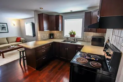 a kitchen with a stove top oven in a room at Grand Boulevard Retreat- quiet suite in North Vanc in North Vancouver