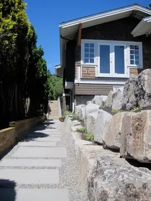 a stone path in front of a house at Grand Boulevard Retreat- quiet suite in North Vanc in North Vancouver