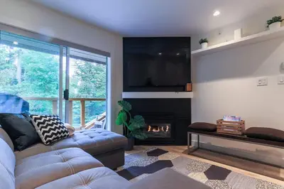 a living room with a couch and a fireplace at Whistler Village North Retreat - Private Hot tub in Whistler