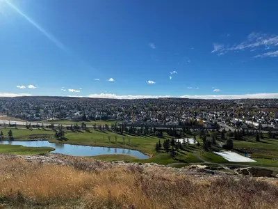 an aerial view of a golf course with two ponds at Biddington private room close airport! in Calgary