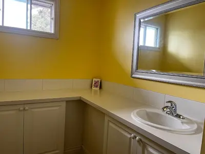 a bathroom with a sink and a mirror at Biddington private room close airport! in Calgary