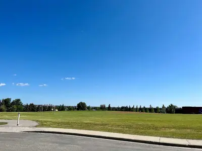 a field of green grass next to a road at Biddington private room close airport! in Calgary