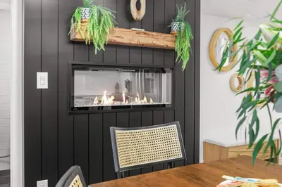 a fireplace in a living room with a fire place at Newly Built 2BR Mountain Escape in DT Canmore! in Canmore