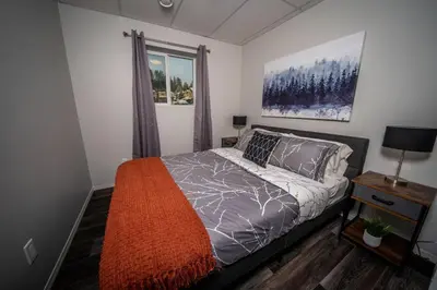 a bedroom with a bed and a window at 3 Bed Townhouse, Mountain Views, Large Deck, Air Con, Garage in Invermere