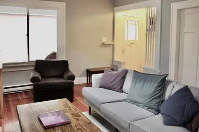 a living room with a couch and a table at Craftsman Home in popular East Village in Vancouver
