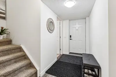 a hallway with stairs and a mirror on the wall at Basement Suite in Calgary - Short Drive to Banff in Calgary