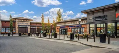 an empty street in front of a shopping center at Basement Suite in Calgary - Short Drive to Banff in Calgary