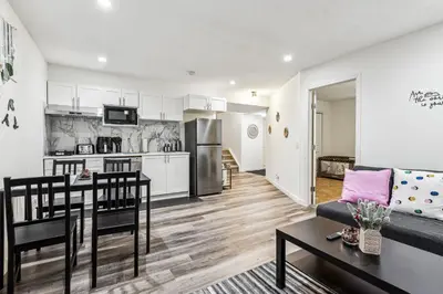 a kitchen and living room with a couch and a table at Basement Suite in Calgary - Short Drive to Banff in Calgary