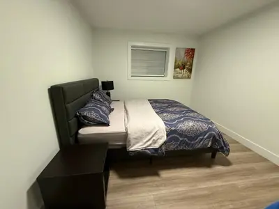 a small bedroom with a bed and a window at Calm & Cozy Private Suite in Surrey