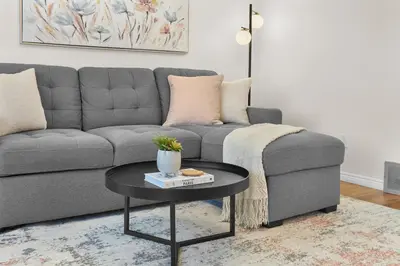 a living room with a couch and a table at Fabulous Home-King bed-Easy Access to EVERyTHING! in Edmonton