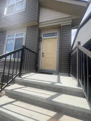 a house with a yellow door on a porch at Edith Gate Luxe Bedroom 2 Homestay in Calgary