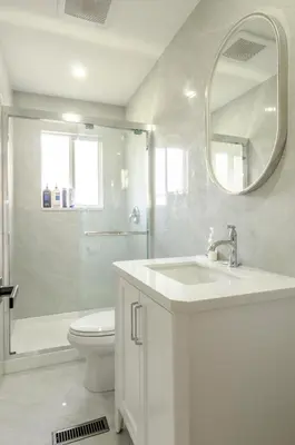 a bathroom with a sink and a toilet and a mirror at Oak Park House in Vancouver in Vancouver